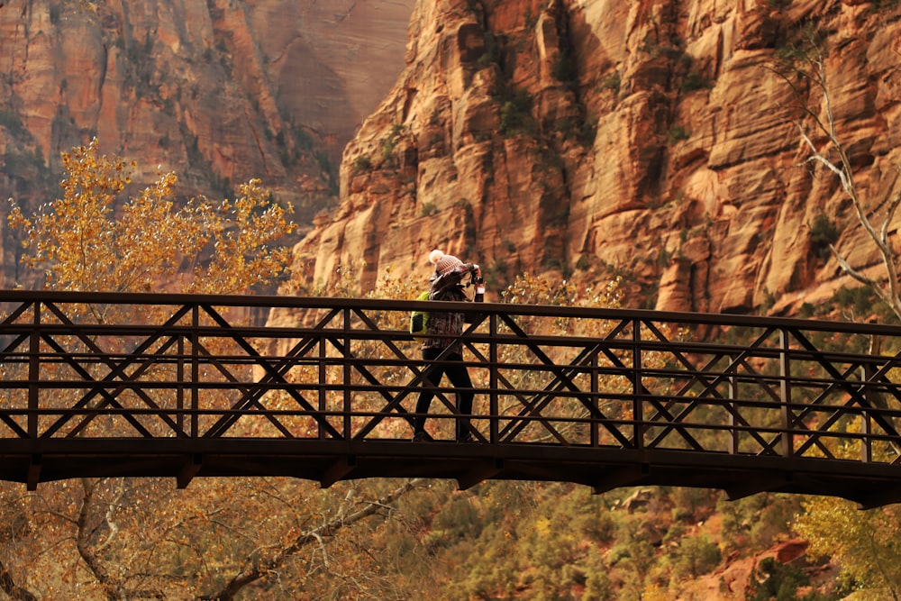 woman crossing on bridge