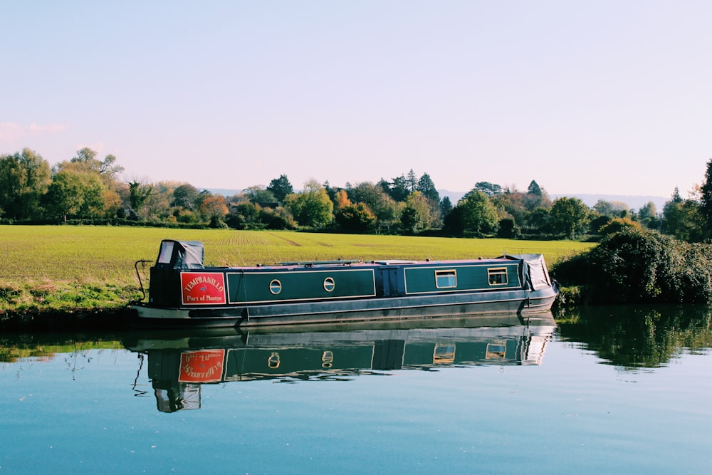 green and beige cuddy boat on body of water