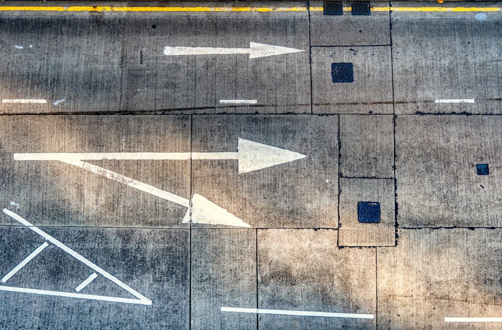 concrete road with painted arrow directions