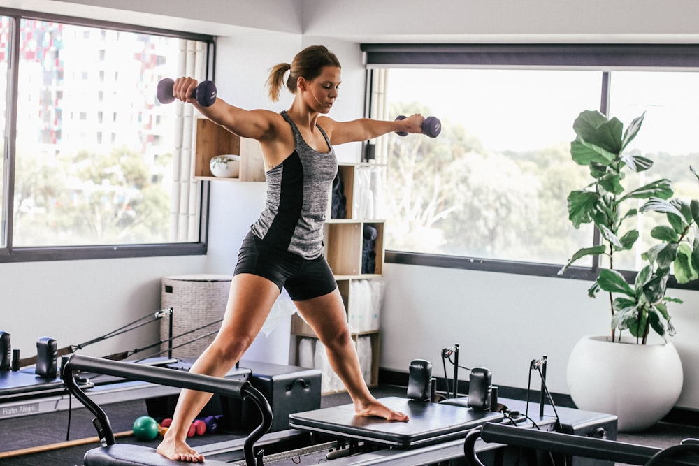 woman doing exercise inside white room