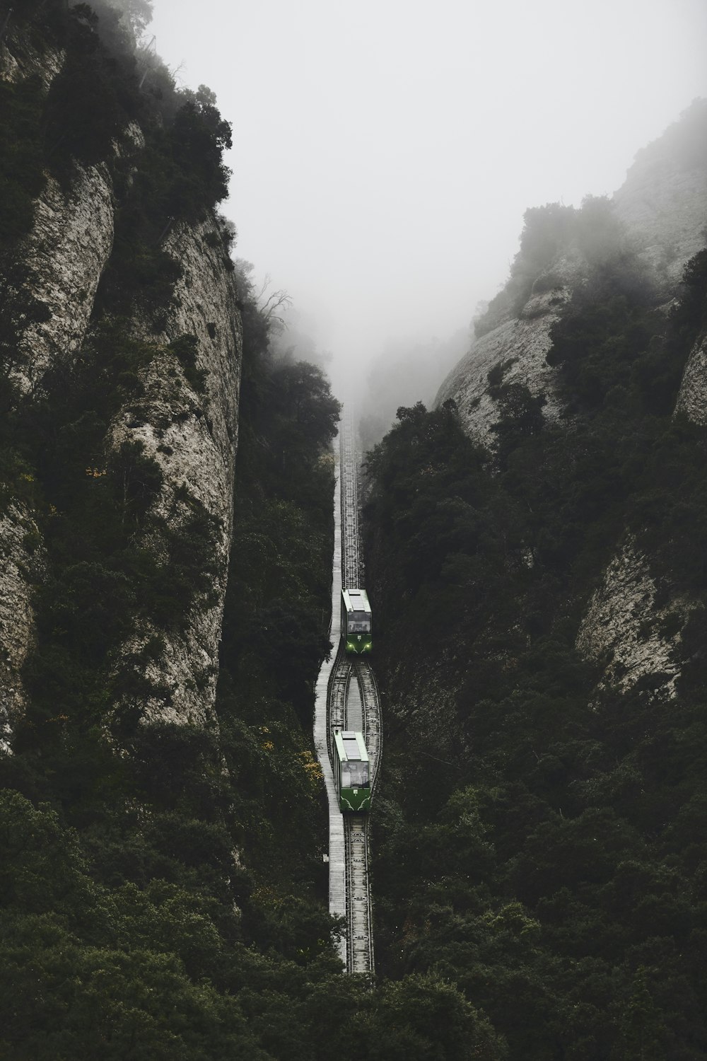 two vehicles between cliffs