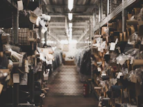 Rows of neatly packed deadstock fabrics inside a modern warehouse.