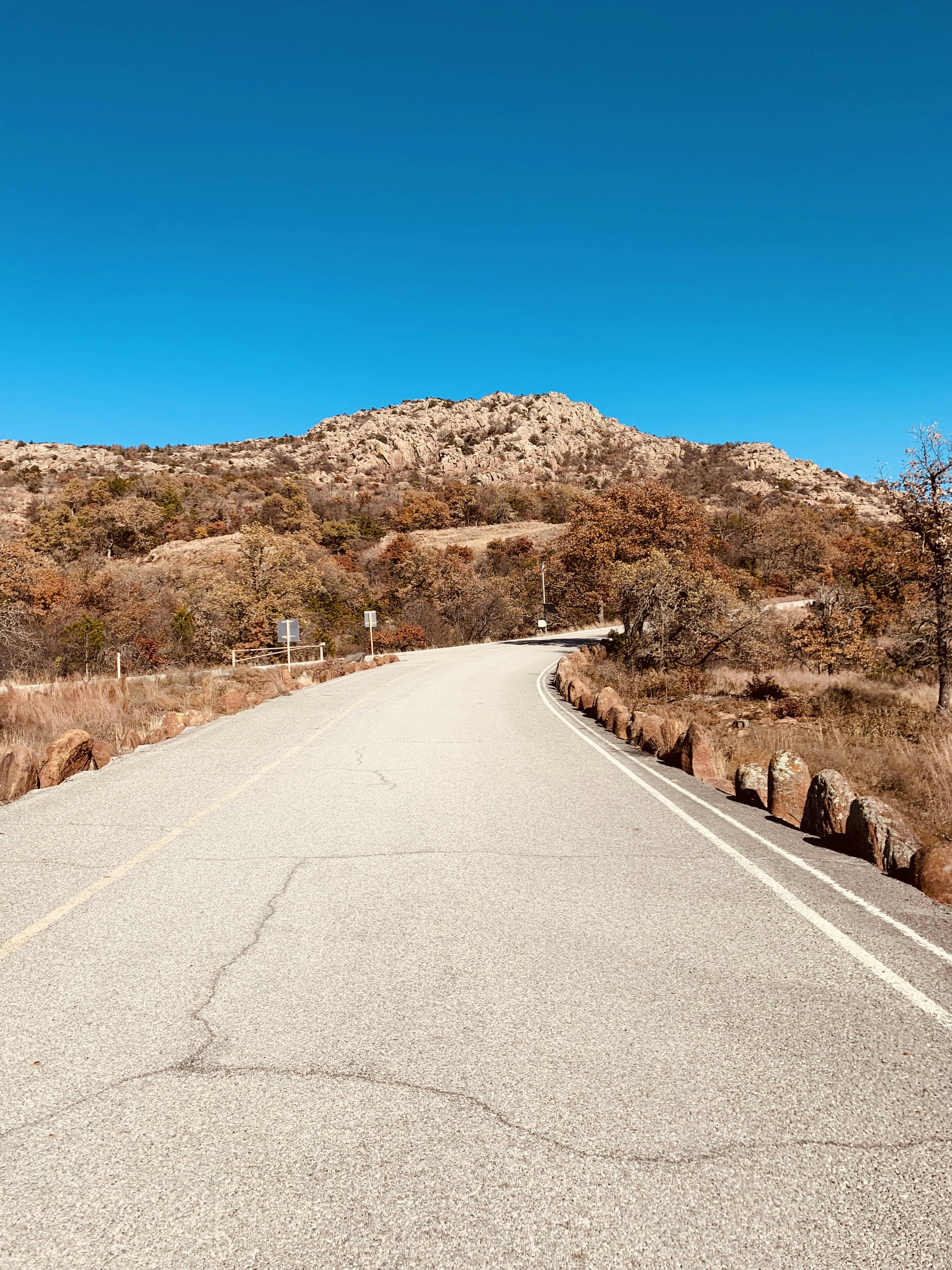 gray concrete road near mountain