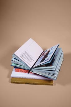 open book on top of several stacked books