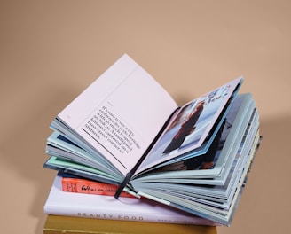 open book on top of several stacked books