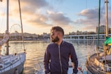 man standing on yacht facing left