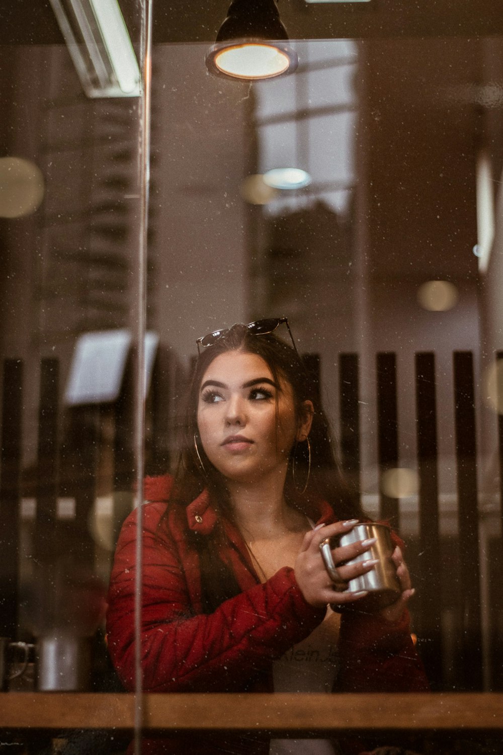 woman holding grey mug