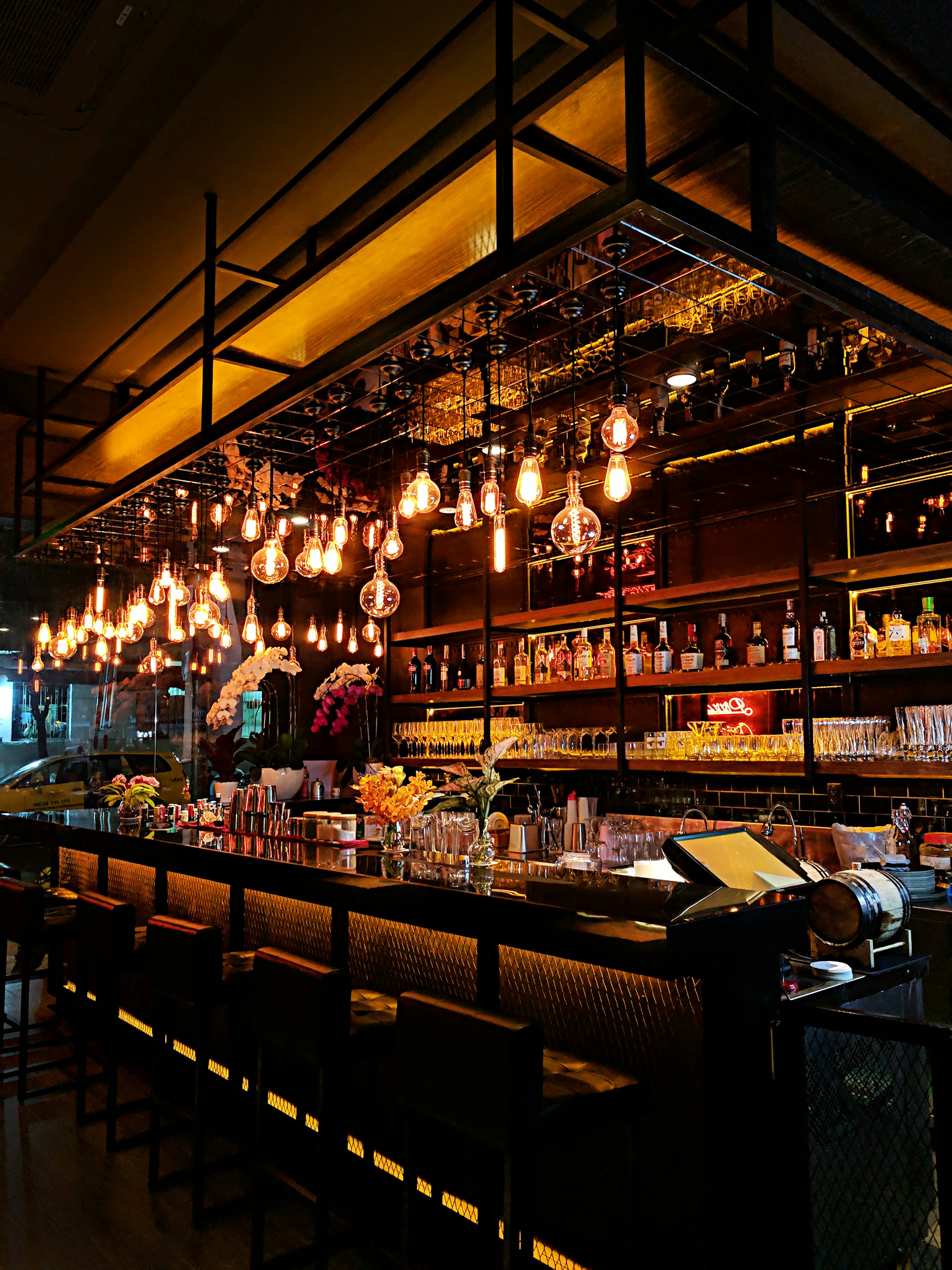 turned-on filament bulb lights at bar counter