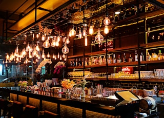 turned-on filament bulb lights at bar counter