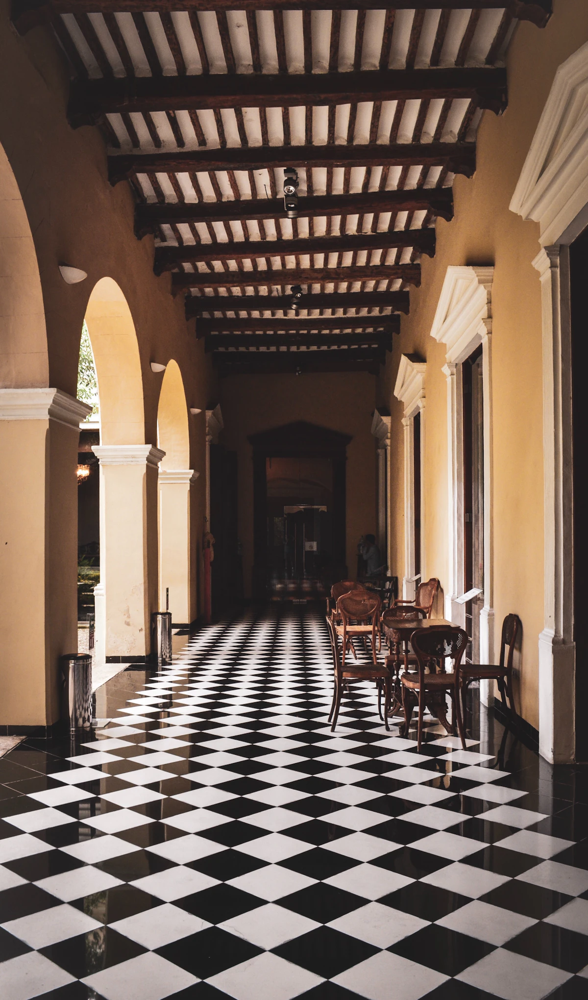 Colonial interior in Mérida, Yucatán, with arches and black-and-white tiles. Illustrative photograph, not one of the hotels named in the article.