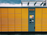 Close-up of a tech-luxury smart locker module with saffron gold accents