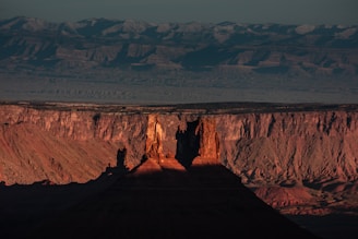 A serene landscape painting showcasing Utah's iconic red rock formations at sunset.