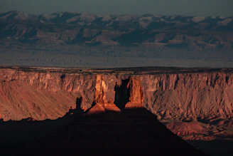 Sunset over St George landscape with red rock formations symbolizing local roots.