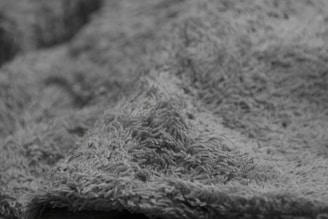A close-up of a soft pillow with a textured fabric.