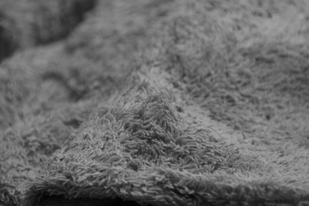A close-up of a soft pillow with a textured fabric.