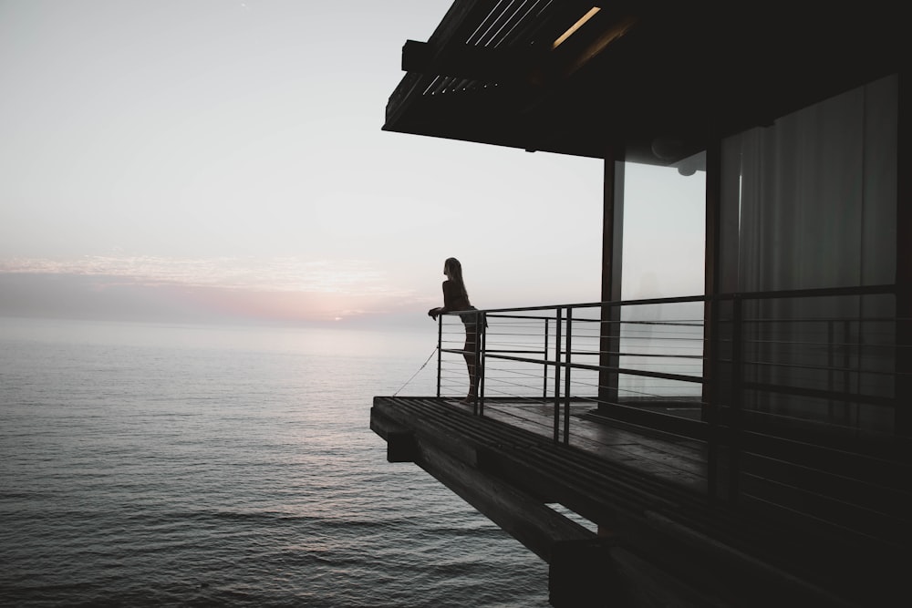 silhoette of woman standing on deck