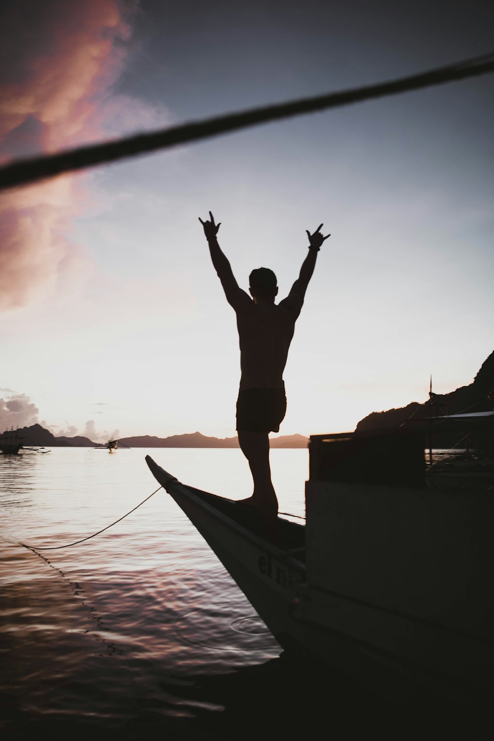 silhouette of person standing on boat