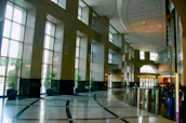 A serene hotel lobby bathed in natural light, inviting guests inside.
