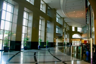 A sparkling clean residential lobby with polished floors and fresh plants.