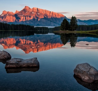 mountain reflection on body of water