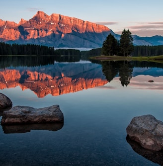 mountain reflection on body of water