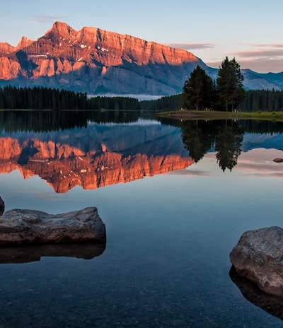 mountain reflection on body of water