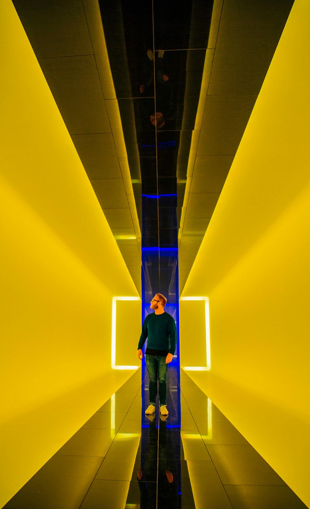 man standing near yellow light