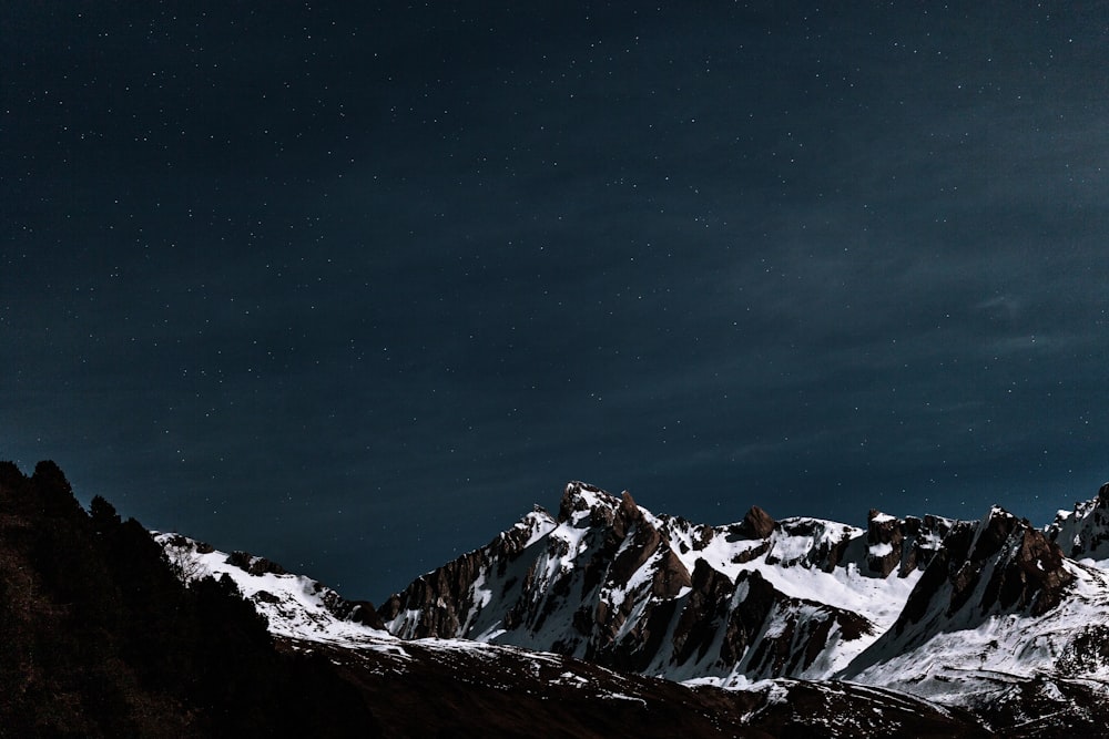 brown and white mountains covered with snow during daytime