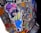 A colorful graffiti sticker depicts a cartoon-style character wearing oversized sunglasses, a purple hat, a yellow shirt, and blue overalls. The background features a mix of vivid colors and abstract shapes, including polka dots, with the word 'TRENDSETTER' partially visible.