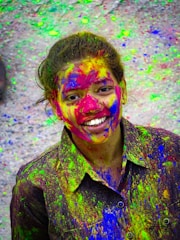 A joyful person smiling while surrounded by colorful confetti