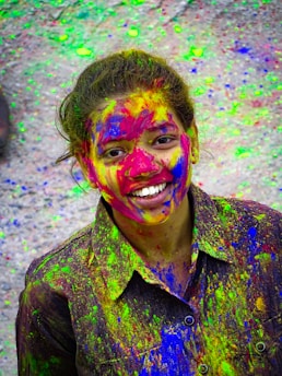 A joyful person smiling while surrounded by colorful confetti