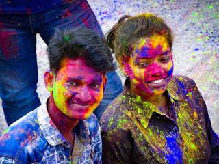 Smiling friends posing with face paint at a lively community fair in Atlanta.