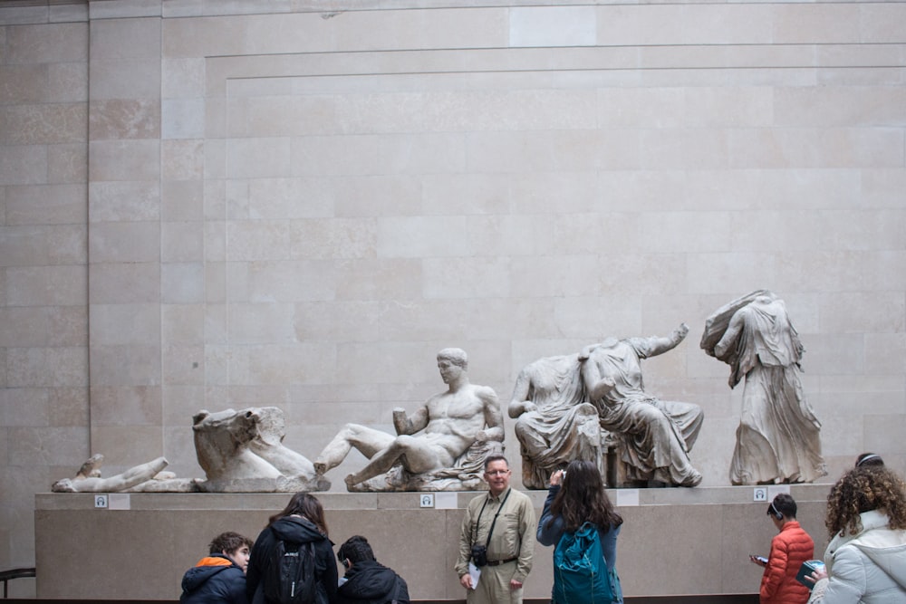 man standing behind of statue