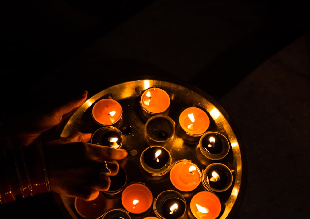 person near tealight candles