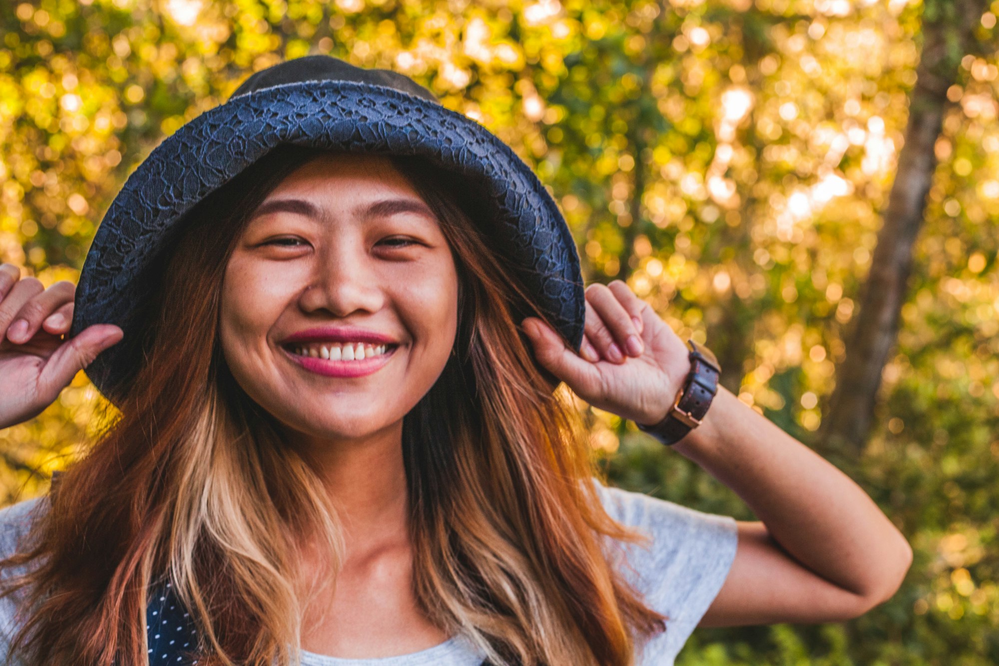 smiling teenager wearing a hat