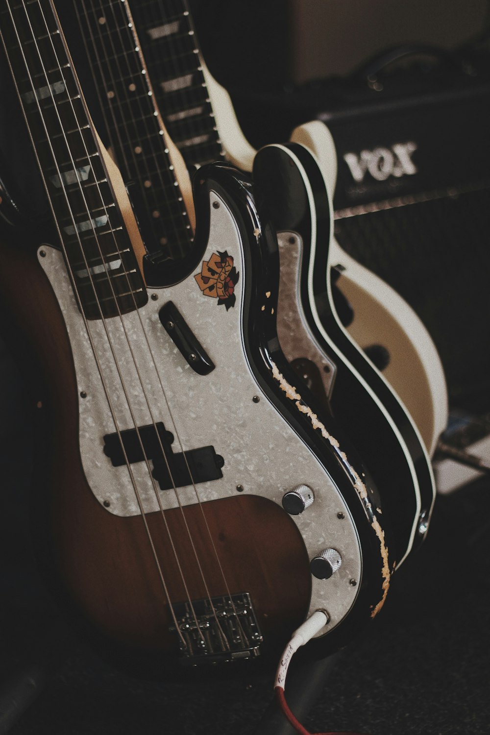 brown and black bass guitars