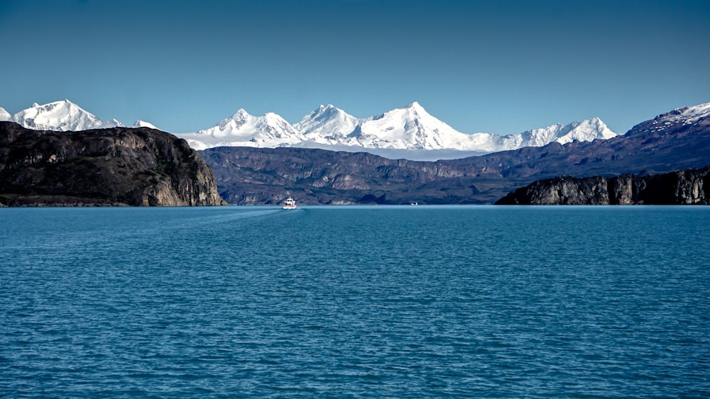 white mountains in front of body of water