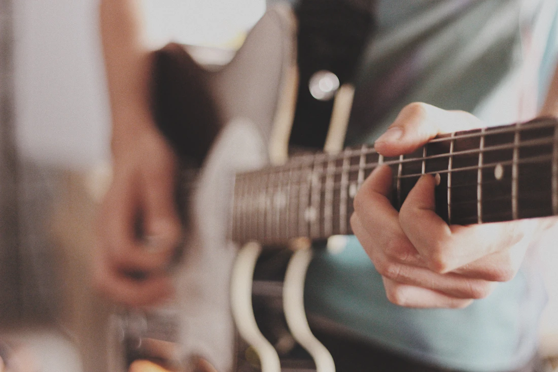 Elektro gitar çalan öğrenci