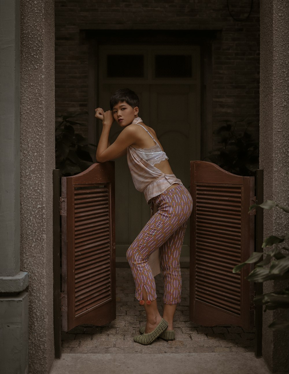 woman leaning forward on wooden door