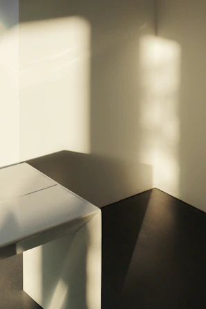 Warm sunlight casting soft shadows over a minimalist altar with healing elements