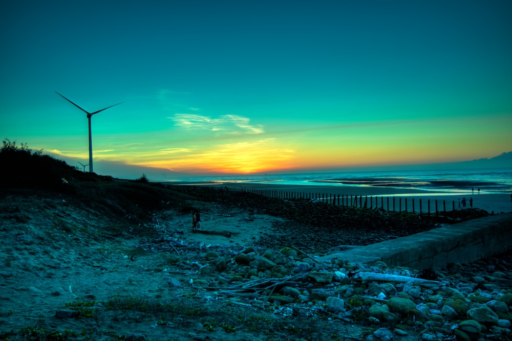 wind mill near body of water