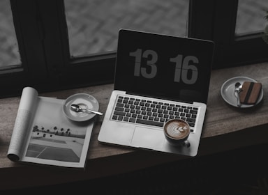 A tennis analyst reviewing match statistics on a laptop.