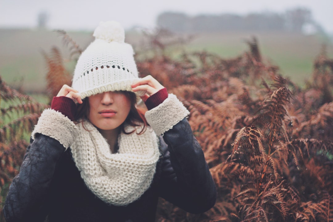 woman cover eye of knit cap