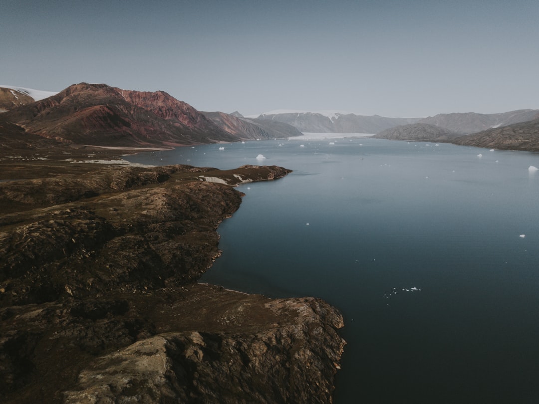 lake and mountains during day