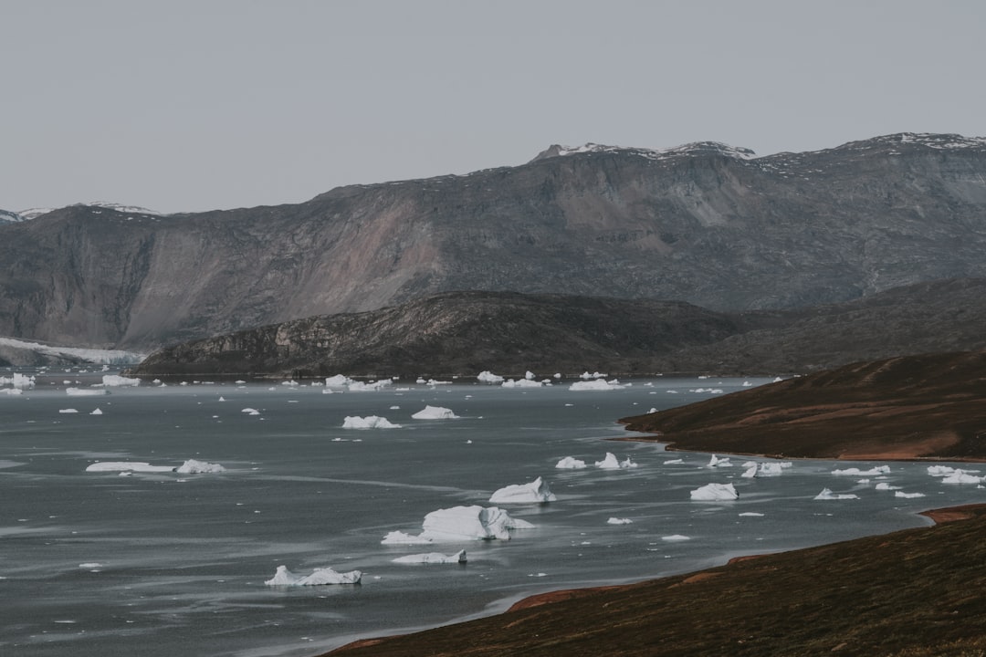 mountain near body of water during daytime