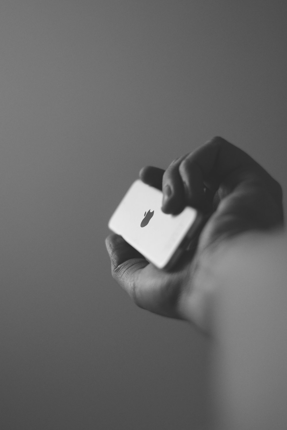 grayscale photography of person holding iPod