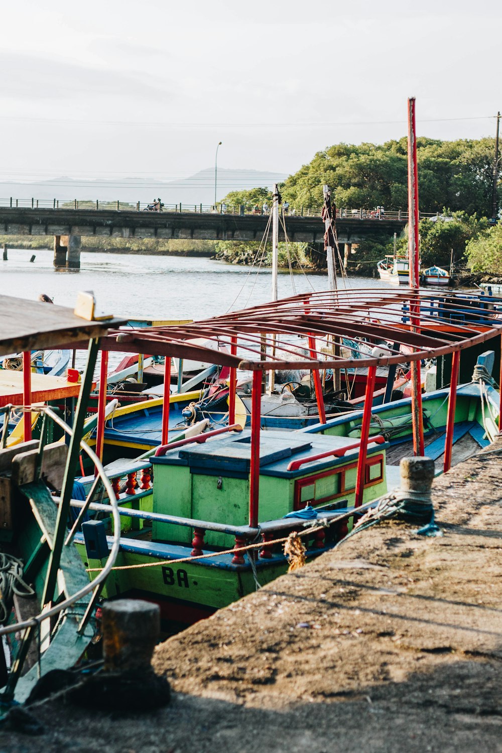 red and green boat on dock at daytime