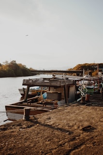 A rustic wooden boat moored by the river, reflecting the maritime heritage of the region.