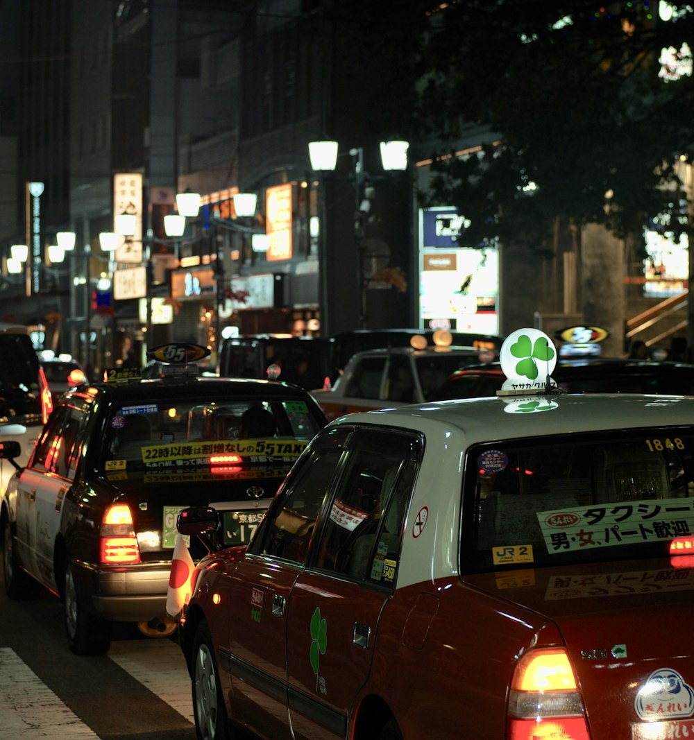 red and white vehicle running on the street during nighttime