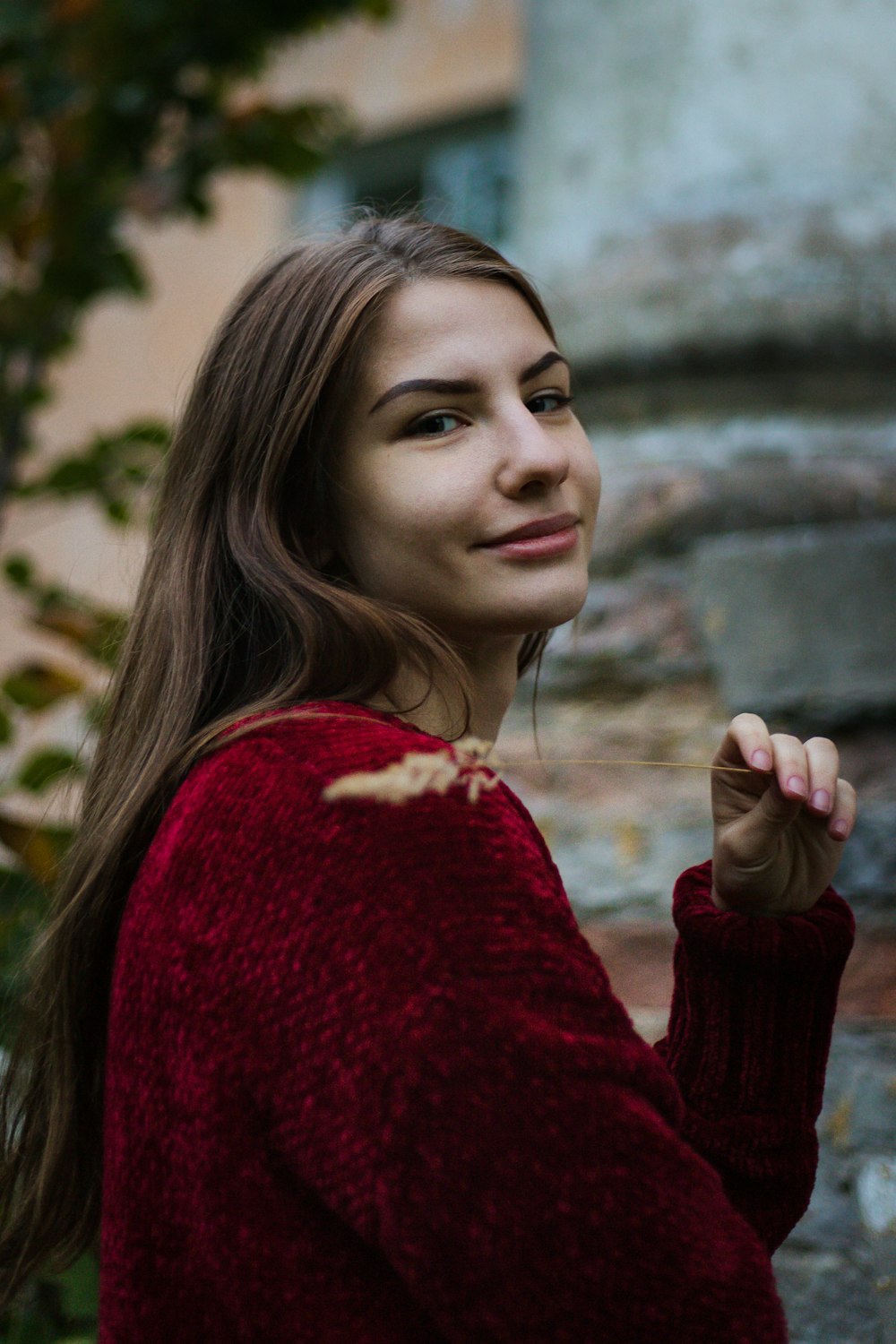 shallow focus photo of woman in maroon sweater